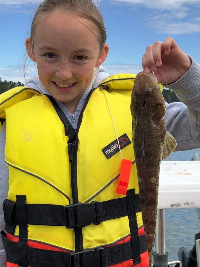 Brianna Tate with her first flathead for the season, measuring just under 40cm and caught off Lewisham using squid as bait.