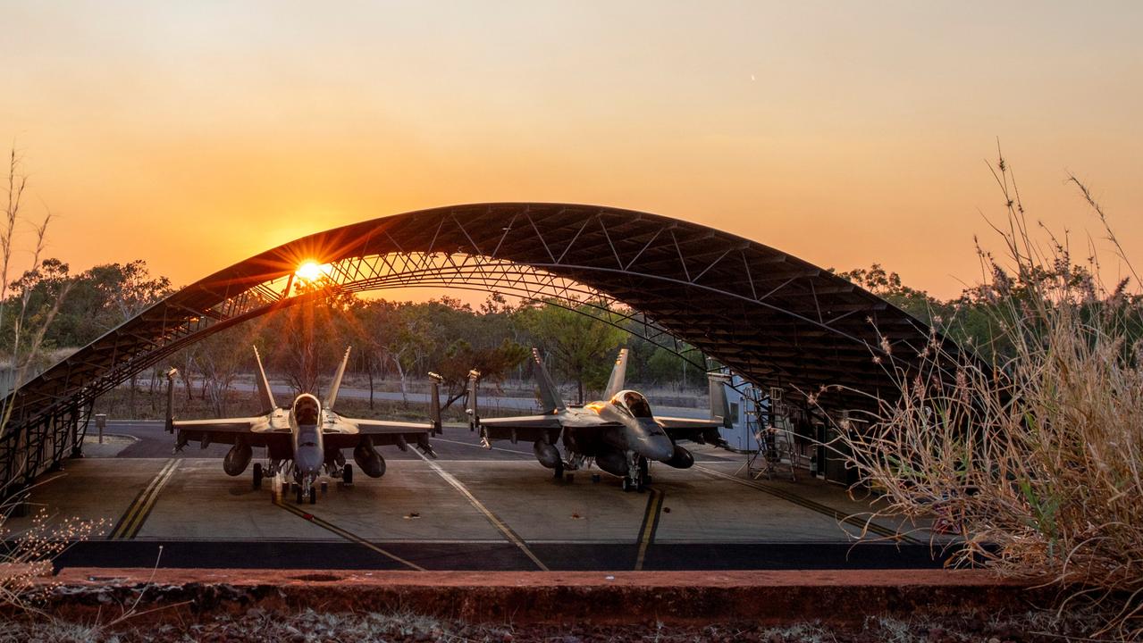 The sun setting behind two Royal Australian Air Force F/A-18F Super Hornets in the Ordnance Loading Area at RAAF Base Tindal, Northern Territory. Picture: Supplied.