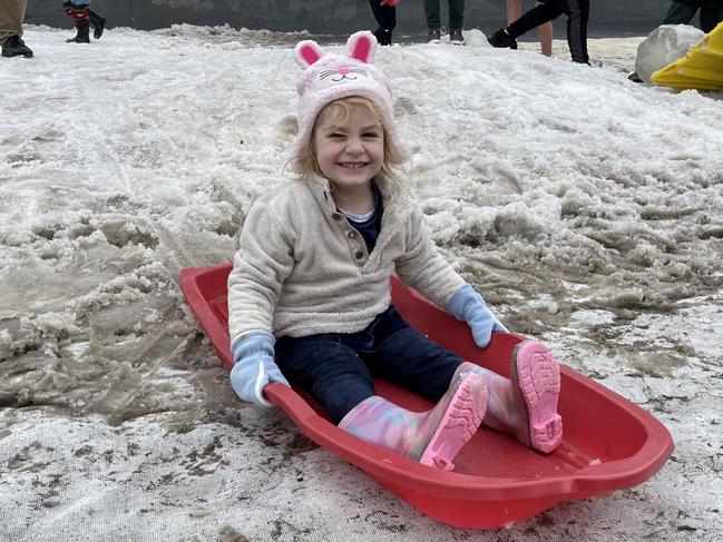 Three-year-old Melanie Cornish is having a blast tobogganing on the snowfields on day 2 of the 2021 Snowflakes in Stanthorpe festival. Photo: Madison Mifsud-Ure / Stanthorpe Border Post