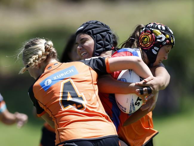 Lily Porter is tackled by Isabelle Fitzpatrick. Picture: Michael Gorton