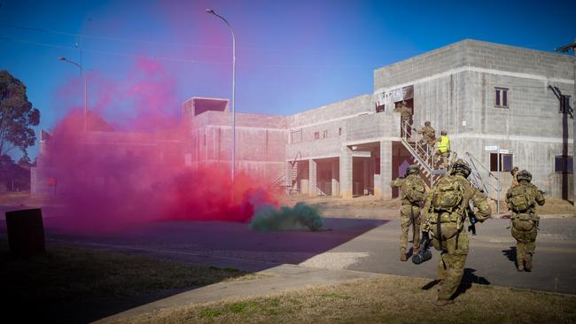 Australian army soldiers from the 3rd Battalion, Royal Australian Regiment, clear a building building during the conduct of an urban assault serial using the Blue Bolt non-lethal training ammunition, as part of the 2022 Duke of Gloucester Cup in Singleton. *** Local Caption *** Australian Army infantry soldiers from across Australia tested their core skills for the prestigious Duke of Gloucester Cup at the School of Infantry, near Singleton in NSW, July 31 - August 5 2022. The Duke of Gloucester Cup is the Armyâ€™s premier military skills competition, pitting the best Royal Australian Corps of Infantry rifle sections from each unit against one another through a series of challenging activities that test their core infantry skills, including marksmanship, tactics, teamwork and fitness. Along with the Duke of Gloucester Cup, five other trophies are awarded: Sir Arthur MacDonald Trophy for best foundation war-fighting skills; Gurkha Trophy for best live-fire shooting; Royal Ulster Rifles Trophy for best falling plate shooting; OSCMAR Trophy for best battle endurance; and the DSM Roche CSC Memorial Cup for best individual soldier. The Duke of Gloucester Cup was created by Prince Henry, Duke of Gloucester, in 1946, while serving as the Governor-General of Australia.