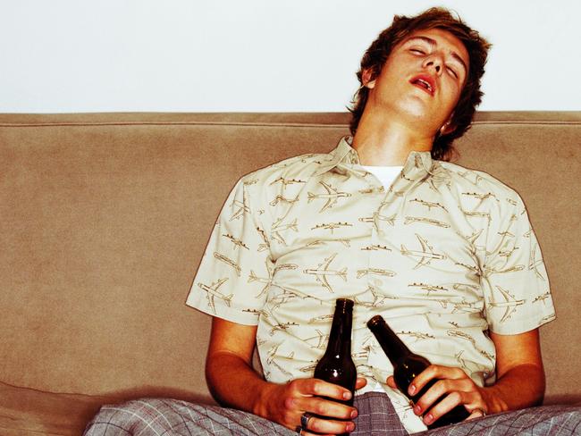 21/05/2012 NEWS: Portrait of a young man asleep on the couch after drinking too much beer. Hangover. Alcohol. Generic. Pic. Thinkstock Supplied /