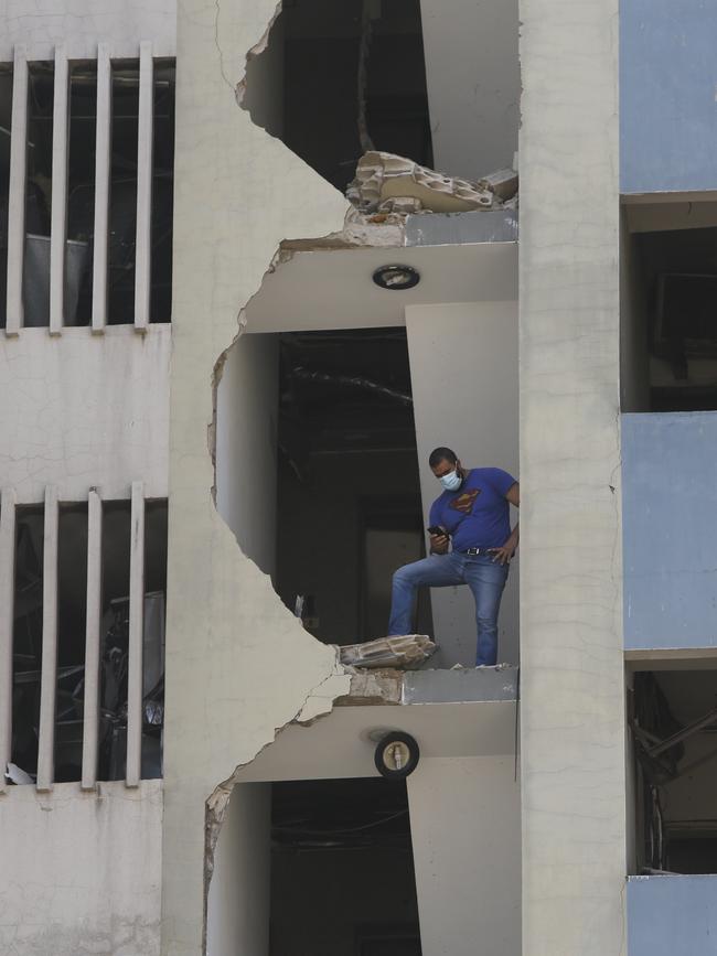 A man stands on the collapsed facade of a building. Picture: Marwan Tahtah/Getty