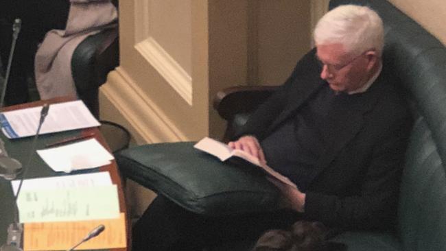 Enfield MP and former Labor deputy premier John Rau catches up on some quality reading in State Parliament.