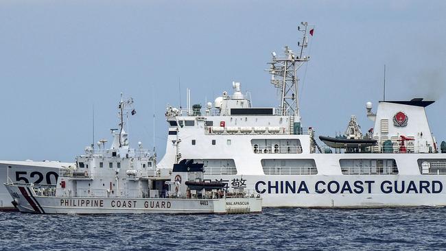 A Chinese coast guard ship this April cuts the path of a Philippines vessel at Second Thomas Shoal in the Spratly Islands in the disputed South China Sea. Picture: AFP