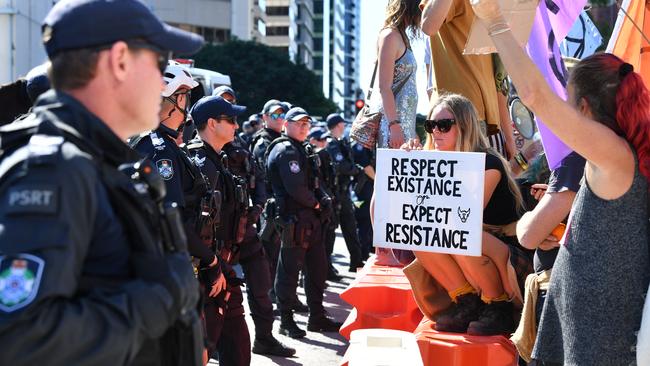 Extinction Rebellion protestors are seen blocking the corner of Margaret and William Streets in Brisbane, Tuesday, August 6, 2019. Climate change protestors are planning to shut down Brisbane's CBD. (AAP Image/Darren England). NO ARCHIVING