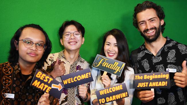 The first group of international students to arrive back to Australia since the introduction of border restrictions has been welcomed back to Charles Darwin University after their release from quarantine. Having fun in the photo booth were, from left, Rifqi Susanto Putra of Indonesia, Nicholas Kurniawan of Indonesia, Po Yan Wang of Hong Kong and Francois Brassard of Canada. Picture: Katrina Bridgeford