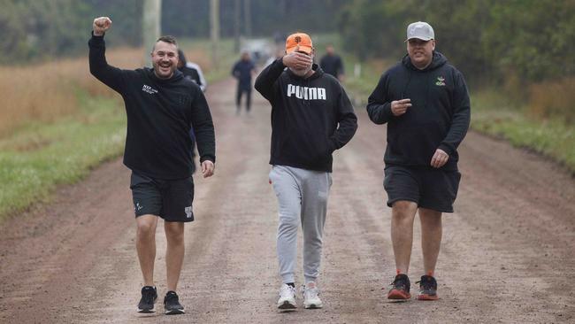 A camera-shy Andrew O’Keefe (centre) on the obligatory daily 5.30am walk at the Connect Global rehab centre. He is with Tony Bull (left) and Adam Ritchie, two volunteers who successfully went through rehabt and stayed on as volunteers. Picture: David Swift