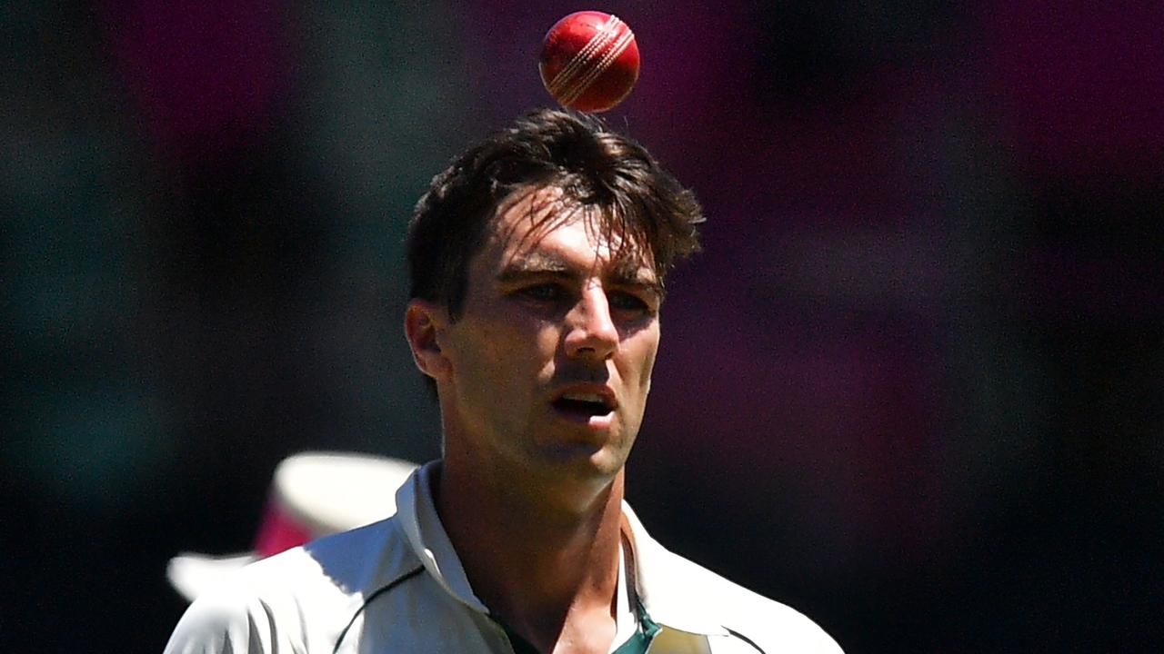 Australia's Pat Cummins tosses the ball as he prepares to bowl during the fifth day of the third cricket Test match between Australia and India at the Sydney Cricket Ground (SCG) in Sydney on January 11, 2021. (Photo by Saeed KHAN / AFP) / -- IMAGE RESTRICTED TO EDITORIAL USE - STRICTLY NO COMMERCIAL USE --