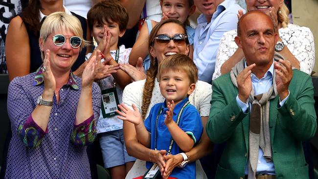 Jelena Djokovic (C), wife of Novak Djokovic of Serbia, and their son Stefan Djokovic applaud.