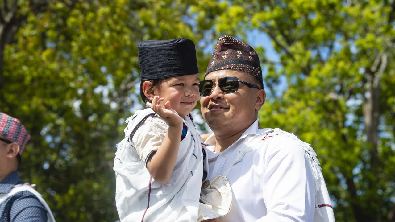 Prem Lama carrying Jason Lama while walking in the Nepalese in Toowoomba entry in the Grand Central Floral Parade of Carnival of Flowers 2022, Saturday, September 17, 2022. Picture: Kevin Farmer