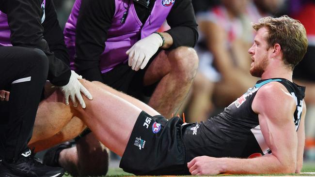 Tom Jonas of the Power has his leg checked by medical staff during the Round 16 AFL match against St Kilda. Picture: AAP Image/David Mariuz