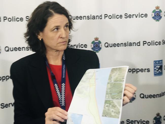 Detective Inspector Sonia Smith holds up a map of the murder scene and search area at Wangetti Beach. Picture: Peter Michael