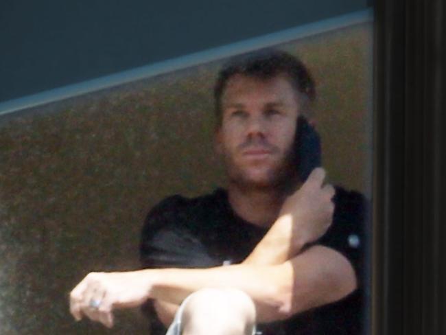 David Warner pictured in the window of his Sydney hotel suite last night. Picture: Matrix