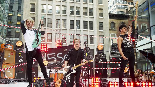 5 Seconds of Summer band members, from left, Michael Clifford, Luke Hemmings and Calum Hood perform on NBC's 