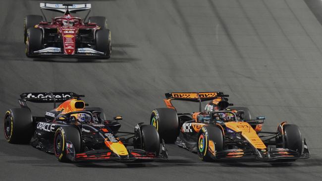 Red Bull driver Max Verstappen of the Netherlands, left, steers his car followed by McLaren driver Oscar Piastri of Australia during the Formula One Saudi Arabian Grand Prix. (AP Photo/Darko Bandic)