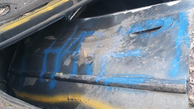 The car door with the words “I hate n” was found torn off a few metres away from the dumped wreck.