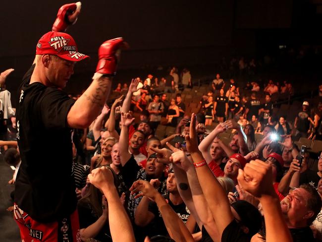 PHOENIX - AUGUST 13: Joe Riggs celebrates with fans after defeating Louis Taylor (not pictured) in the Strikeforce Challengers Men's Main card bout at Dodge Theater on August 13, 2010 in Phoenix, Arizona. (Photo by Christian Petersen/Getty Images)