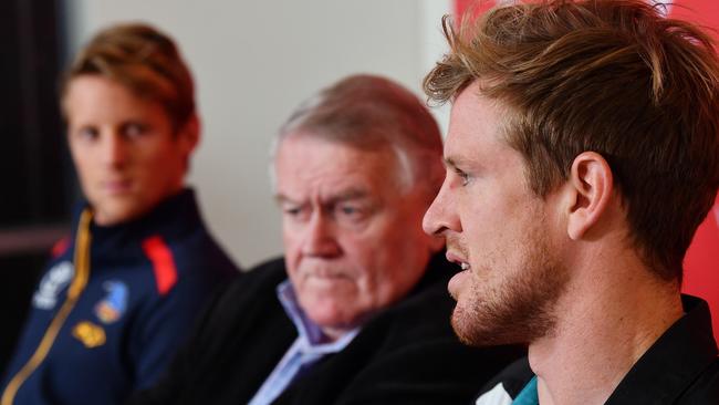 Crows co-captain Rory Sloane and Power co-captain Tom Jonas with Variety SA’s Rob Kerin on Monday morning. Picture: Mark Brake (AAP)