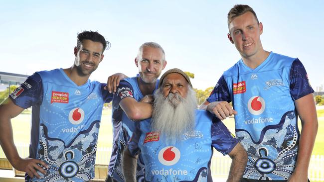 Adelaide Strikers coach Jason Gillespie (second from left) with ‘Uncle Moogy’ and Strikers fast bowlers Wes Agar (left) and Billy Stanlake (right) as they show of the indigenous shirt the team will wear against the Perth Scorchers at Adelaide Oval on Monday night. Picture: Dean Martin (AAP)