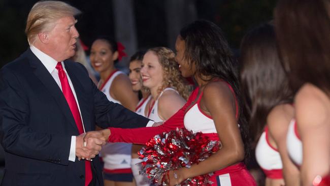 Donald Trump greets cheerleaders from Florida Atlantic University before hosting a Super Bowl party at the Trump International Golf Club in West Palm Beach, Florida, yesterday. Picture: AFP