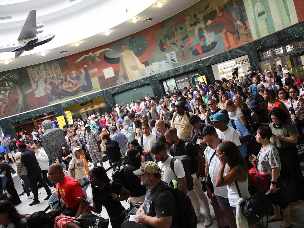 Experts have said the outage could be a “dress rehearsal*” for what a cyber terror attack could look like. Pictured are stranded passengers at La Guardia Airport in New York on July 19. Picture: Leonardo Munoz/AFP