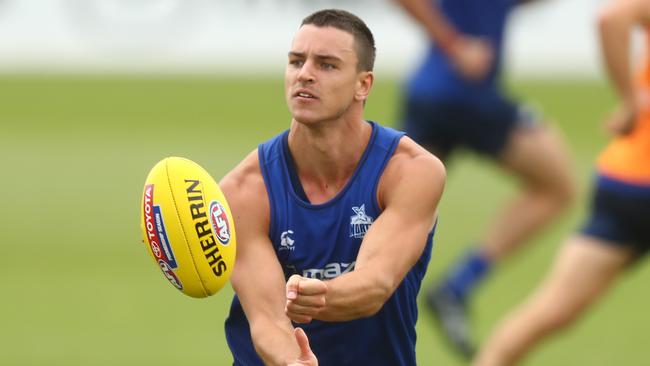 MELBOURNE, AUSTRALIA - JANUARY 18: Luke Davies-Uniacke of the Kangaroos handballs during a North Melbourne Kangaroos AFL training session at Arden Street Ground on January 18, 2021 in Melbourne, Australia. (Photo by Mike Owen/Getty Images)