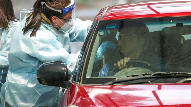 A nurse takes a sample from a motorist at Keilor Community Hub. Picture: Ian Currie