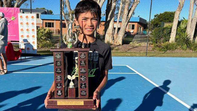 Joshua Burns with the spoils after winning three titles at the NSW Closed Country Championship Junior event at Forster.