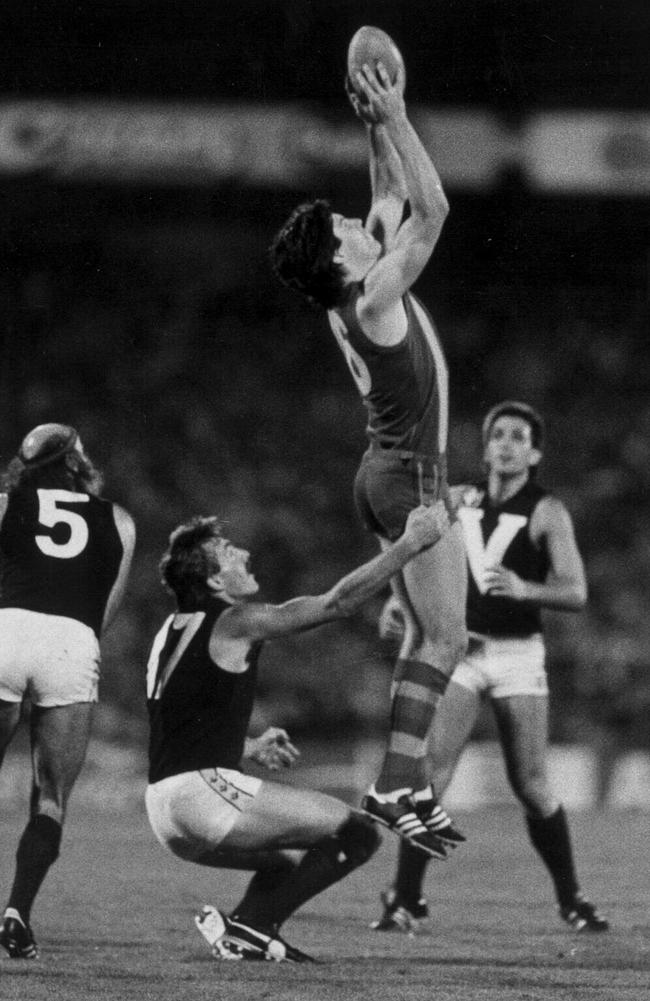 South Australian full-forward Stephen Kernahan marks in front of Victorian opponents Bruce Doull, John Kennedy Jr, and Wayne Johnston as he announced himself on the big stage in 1984.