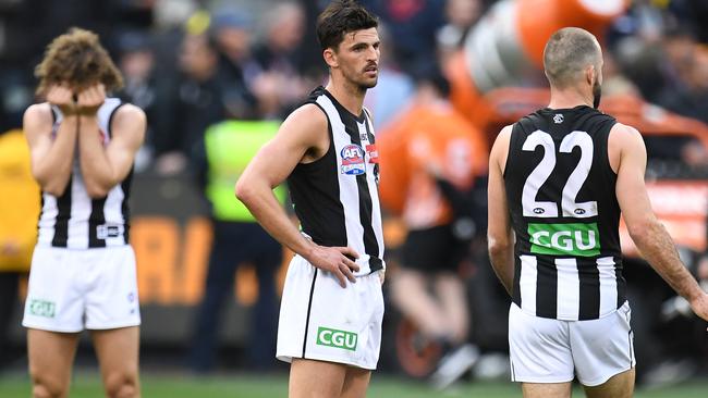 Chris Mayne, Scott Pendlebury and Steele Sidebottom after Collingwood’s loss.