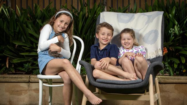 Sophie, 8, with Charlie the rabbit, Jack, 5, and Eliza, 3, at home. Picture: Emma Brasier