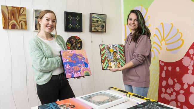 Elysha Rei (left) and Alex Stalling prepare for the Made. Reunion Show featuring 20 artists who exhibited with Made Creative Space between 2011 and 2013. Picture: Kevin Farmer