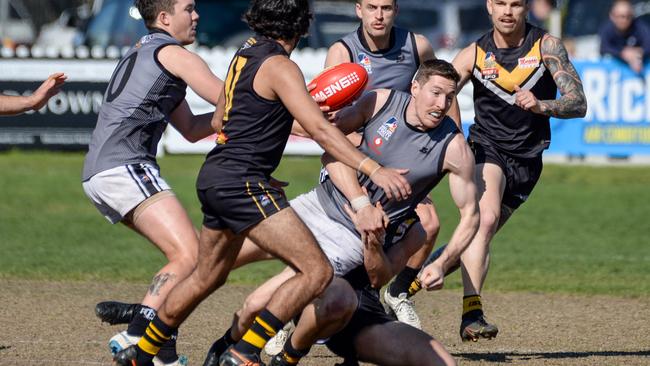 Port District’s Louis Sharrad is tackled during the Adelaide Footy League division one match against Brighton at Brighton Oval. Picture: Brenton Edwards