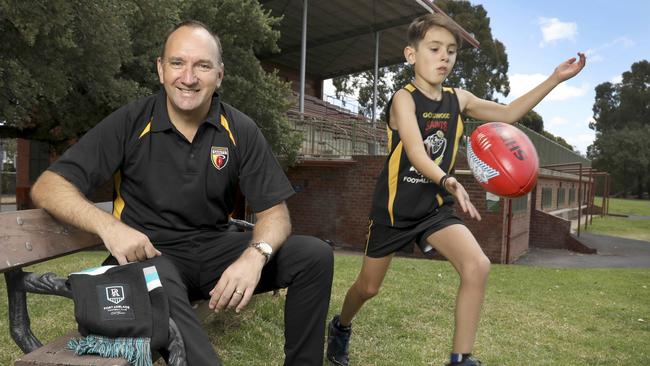 Port Adelaide media manager Daniel Norton is the new Goodwood Saints senior footy manager. Norton, pictured with 10-year-old son Harrison, who plays for the Saints’ juniors. Picture: AAP/Dean Martin