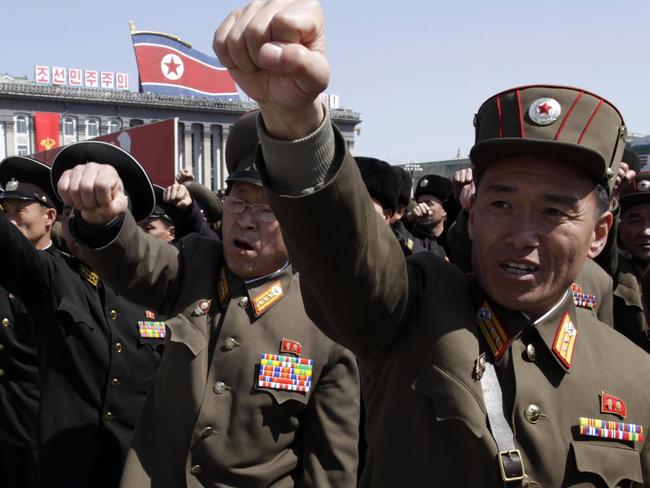 North Korean army officers punch the air as they chant slogans during a rally at Kim Il Sung Square in downtown Pyongyang, North Korea, Friday, March 29, 2013. Tens of thousands of North Koreans turned out for the mass rally at the main square in Pyongyang in support of their leader Kim Jong Un's call to arms. (AP Photo/Jon Chol Jin)