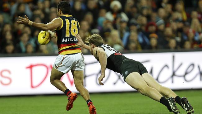 Port Adelaide’s Tom Jonas at full stretch to stop Adelaide’s Eddie Betts.