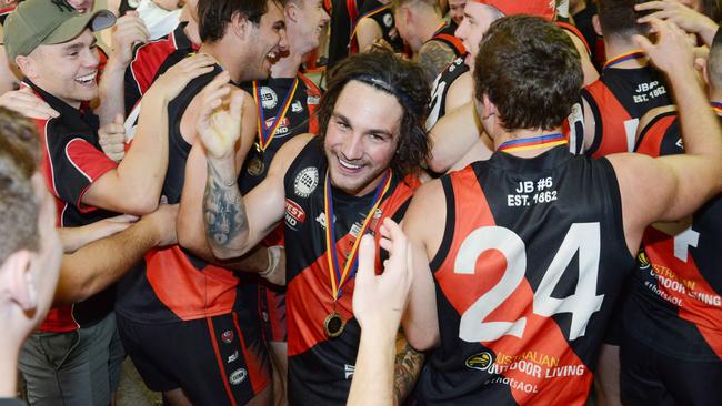 Alex McKay celebrates with Tea Tree Gully players after their 2018 win. Picture: Brenton Edwards