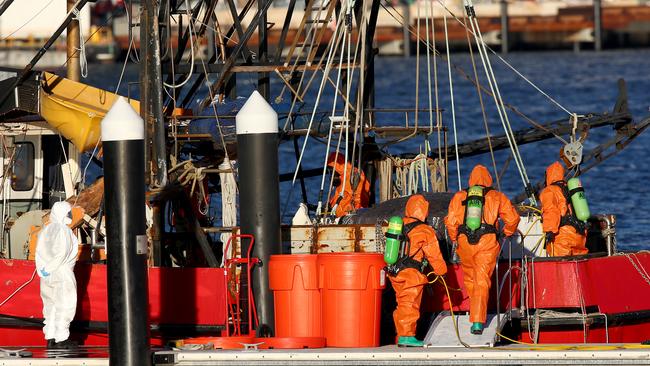 Police and Fire and Rescue NSW personnel in hazmat gear search the fishing trawler 'Coralynne'. Picture: Toby Zerna