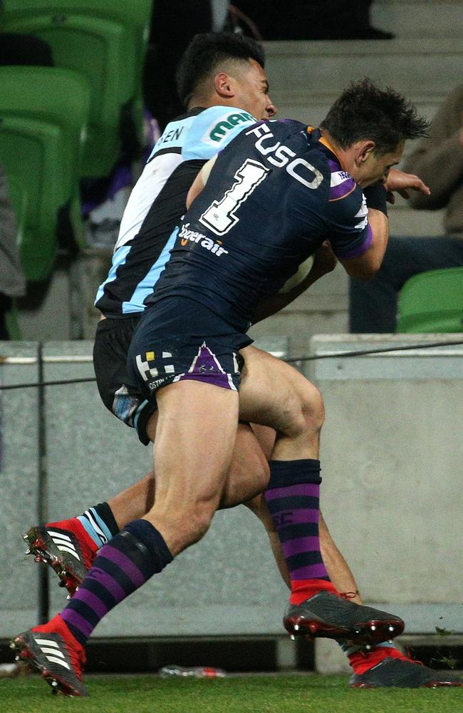 Billy Slater throws himself at Sosaia Feki while attempting to score. (AAP Image/Hamish Blair)