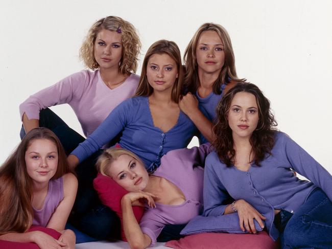 Cast members of the TV show Neighbours in a 2001 photograph. Pictured are (back row left to right) Krista Vendy, Holly Valance and Carla Bonner; and (front row left to right) Kate Keltie, Madeleine West, Kym Valentine.