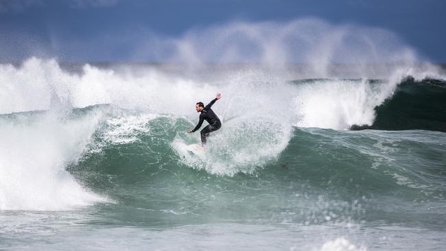 Surfer makes the most of the large swells at Wamberal beach. Picture: NCA NewsWire / Darren Leigh Roberts