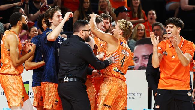 Taipans players and coach Adam Forde celebrate the score line in the National Basketball League (NBL) match between the Cairns Taipans and the Adelaide 36ers, held at the Cairns Convention Centre. Picture: Brendan Radke