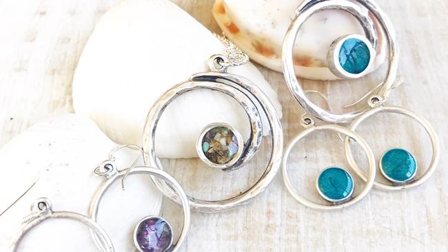 Under the Noosa Collective design label, Cathie Withyman has a range of earrings, necklaces and bracelets, using sand from beaches, to turn memories into physical keepsakes.