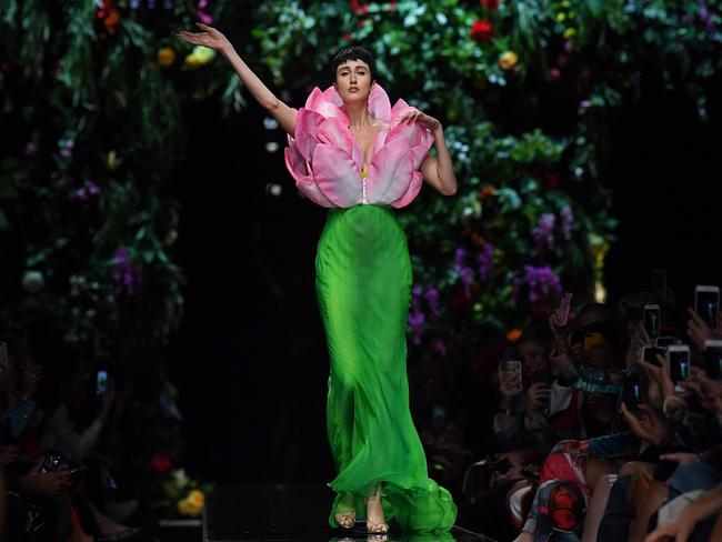 There was a literal deflowering as a model attired as a tulip let her petals flutter into the fashion crowd: Model Anna Cleveland presents a creation for fashion house Moschino. Picture: AFP