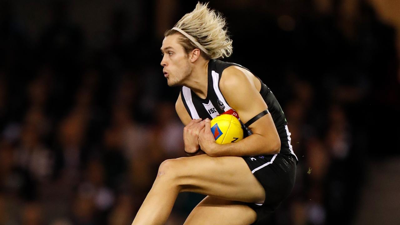 Pies Darcy Moore is in career best form with his blond hair/headband combo. Pic. Michael Willson/AFL Photos