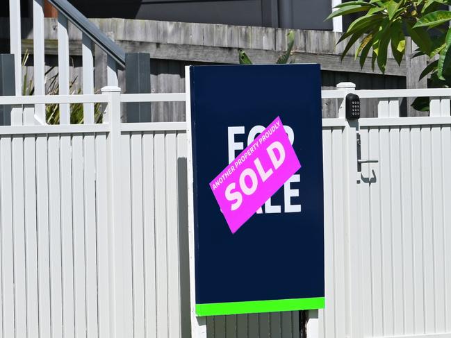 For sale sign in front of a property with a sold sticker over the top