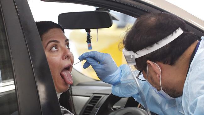 A woman is tested during the steady line of cars rolling up to the site. Picture: David Caird