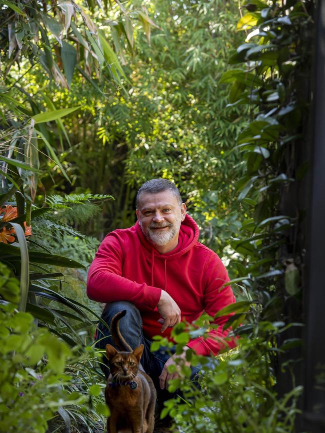 Nick Pettitt in his garden with his cat Floyd. Picture: Andy Brownbill