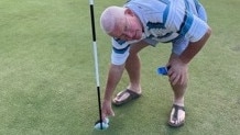 Rowan Braithwaite collects his ball after shooting a hole in one at the Gympie golf course on Tuesday.